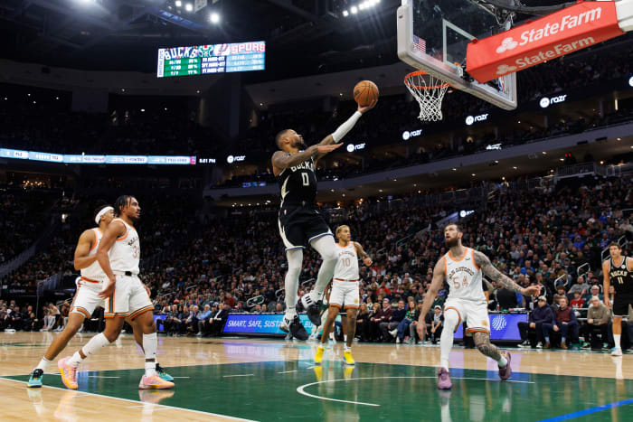Dec 19, 2023; Milwaukee, Wisconsin, USA; Milwaukee Bucks guard Damian Lillard (0) drives for a layup against the San Antonio Spurs at Fiserv Forum.